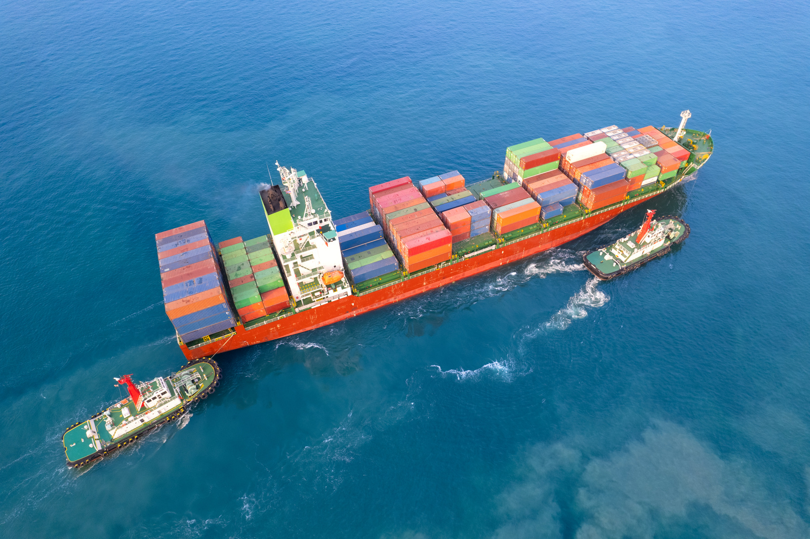 Aerial top view container ship full load container for logistics import export, shipping or transportation concept background. shipyard at sunrise, logistic import export and transport industry background